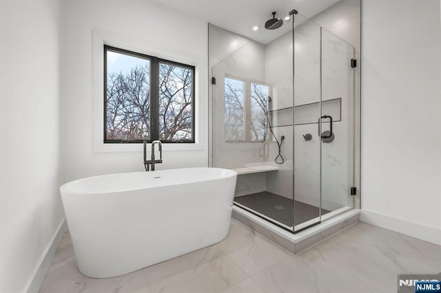 bathroom featuring shower with separate bathtub