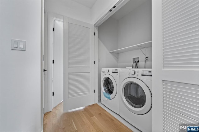 clothes washing area featuring separate washer and dryer and light wood-type flooring