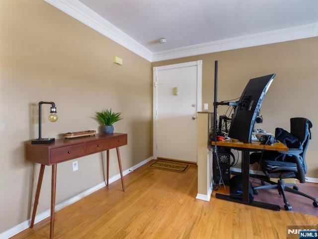 entrance foyer with ornamental molding and light hardwood / wood-style floors