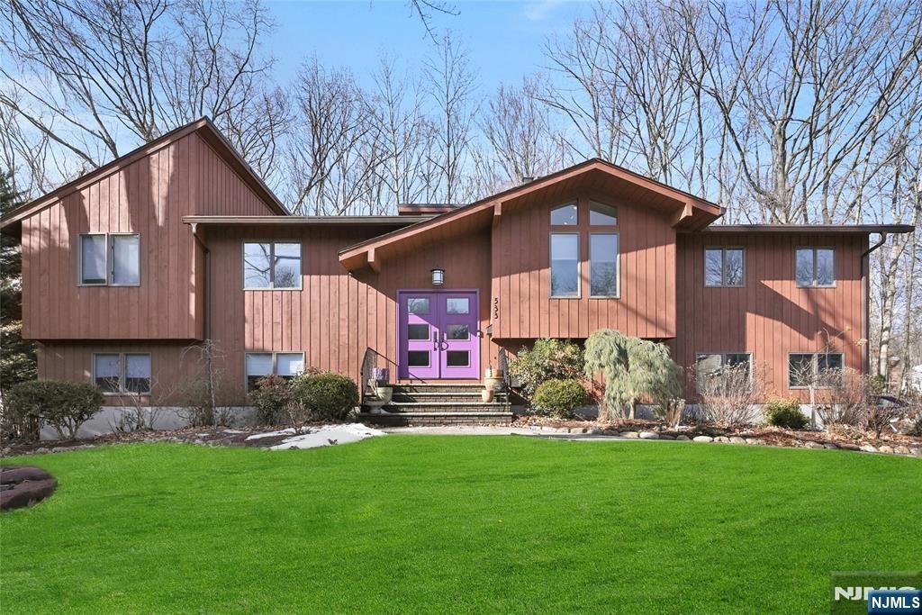 view of front of house with a front lawn and french doors