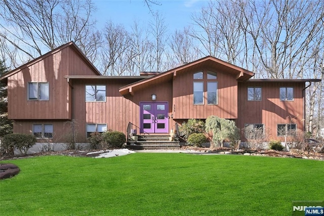 view of front of house with a front lawn and french doors