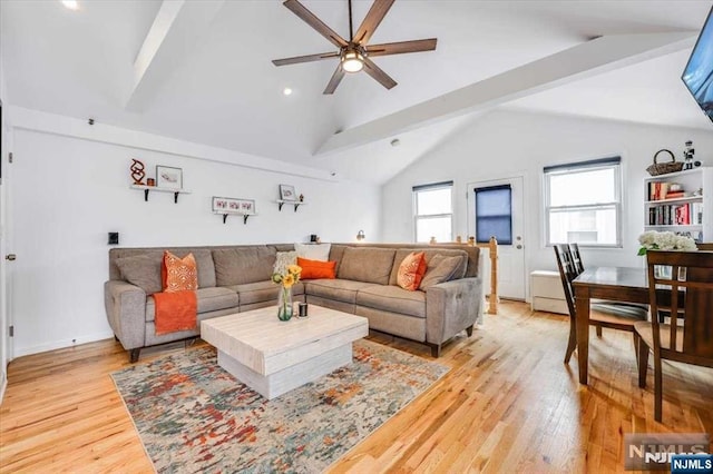 living room with vaulted ceiling with beams, ceiling fan, and light hardwood / wood-style flooring