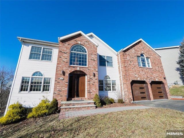 view of front of property with a garage and a front yard