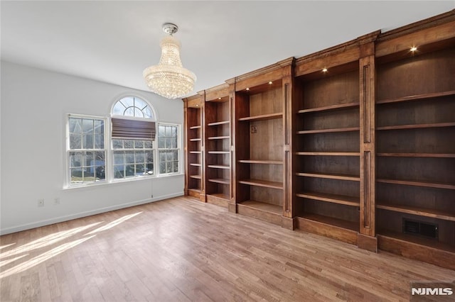 interior space featuring wood-type flooring and a chandelier