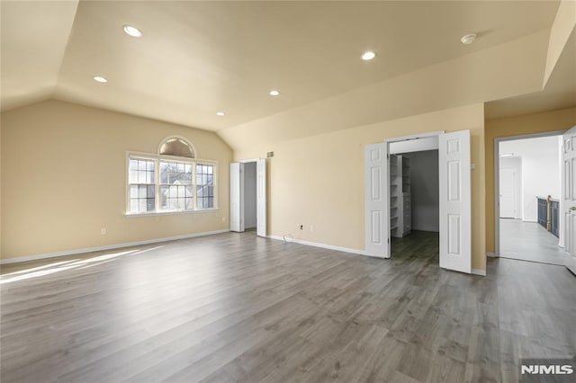 unfurnished living room with lofted ceiling and hardwood / wood-style floors