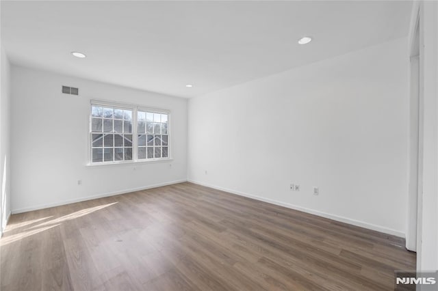 empty room with dark hardwood / wood-style floors