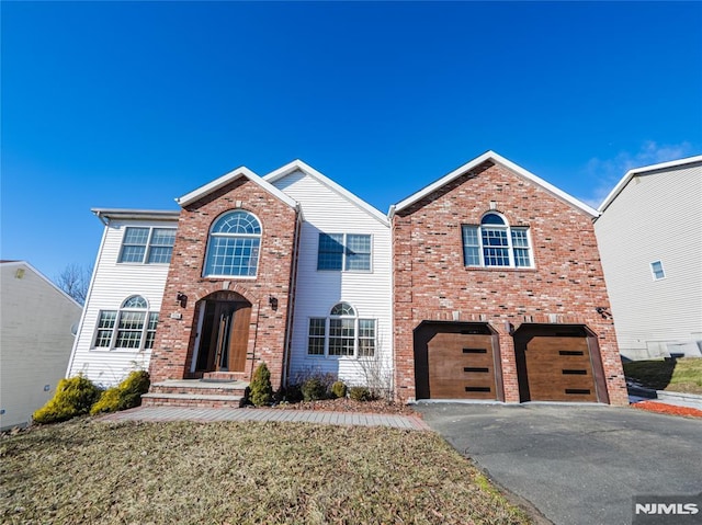 front of property featuring a garage and a front yard