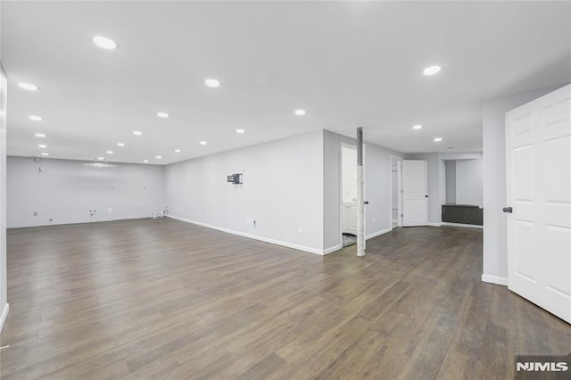 unfurnished living room featuring dark hardwood / wood-style floors