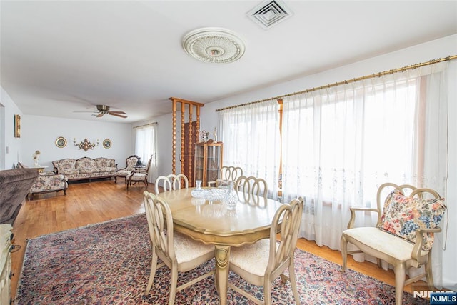 dining area with hardwood / wood-style flooring and ceiling fan