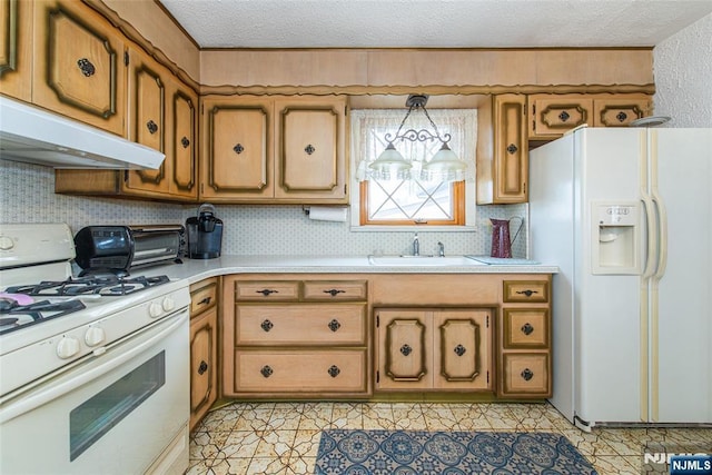 kitchen with sink, a textured ceiling, pendant lighting, white appliances, and backsplash