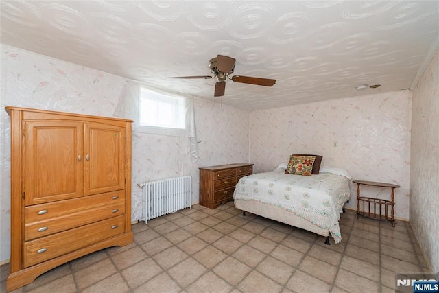 bedroom with radiator and ceiling fan