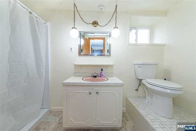 bathroom with vanity, toilet, and walk in shower