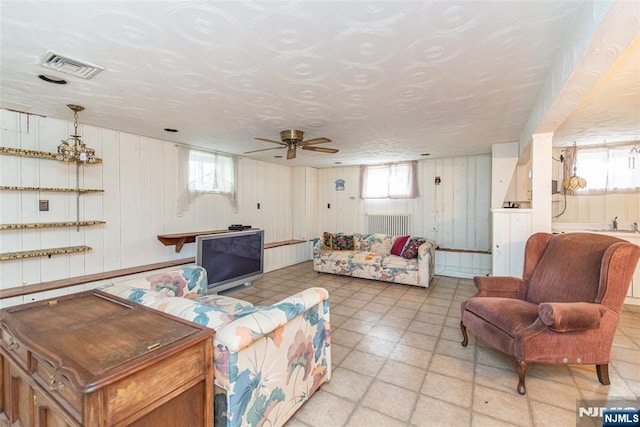 living room featuring a wealth of natural light and ceiling fan