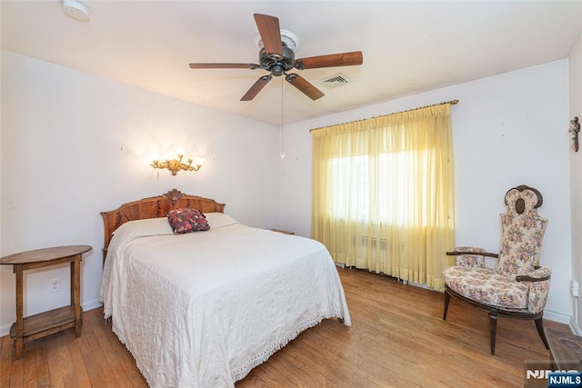 bedroom with wood-type flooring and ceiling fan