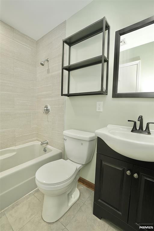 full bathroom with tiled shower / bath, vanity, toilet, and tile patterned flooring