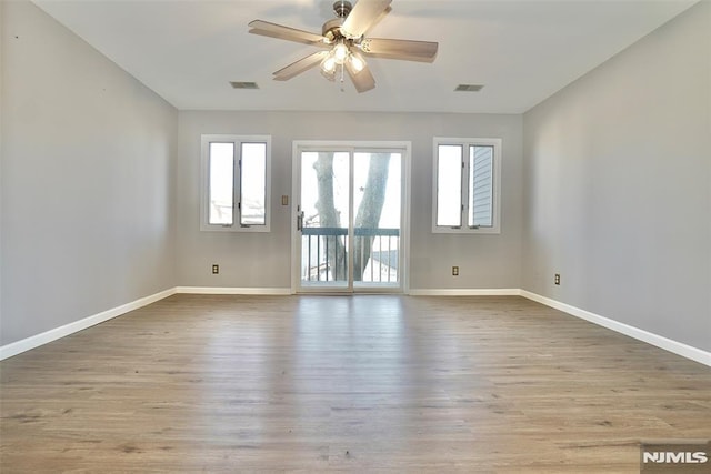 empty room with light hardwood / wood-style flooring and ceiling fan