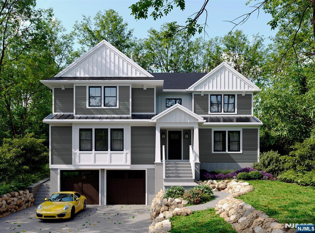 view of front facade featuring an attached garage, board and batten siding, a standing seam roof, metal roof, and driveway