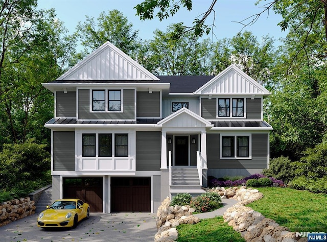 view of front facade featuring an attached garage, board and batten siding, a standing seam roof, metal roof, and driveway