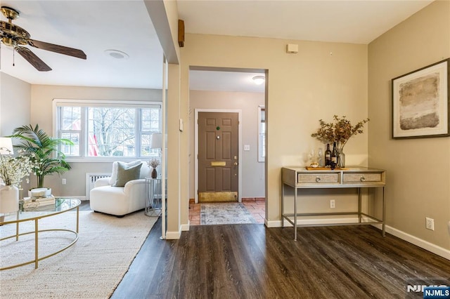 foyer entrance with ceiling fan and dark hardwood / wood-style flooring