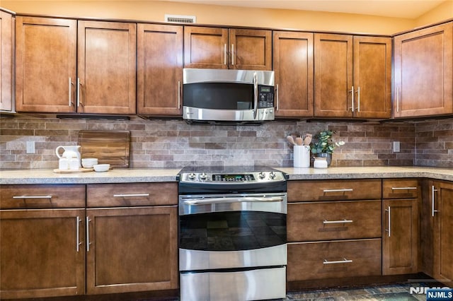 kitchen with tasteful backsplash and stainless steel appliances