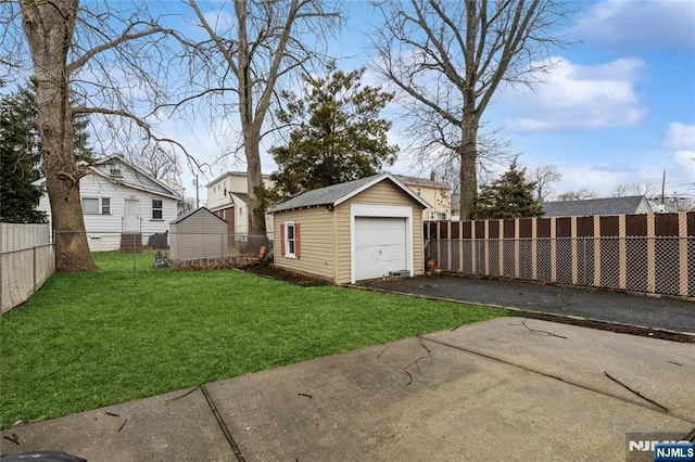 view of yard with a garage and a storage unit