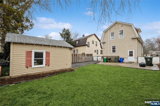 rear view of house featuring a patio area and a lawn