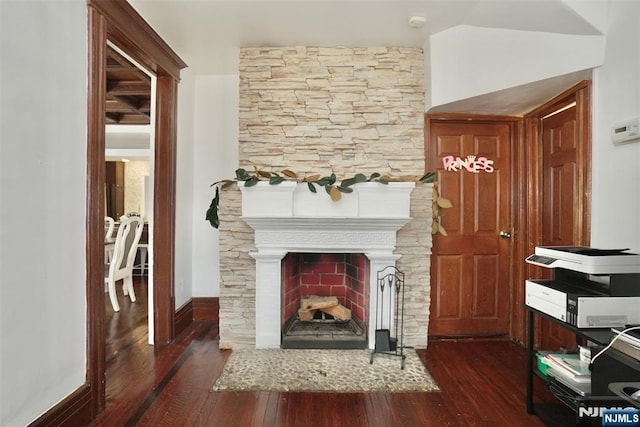 interior details with hardwood / wood-style flooring and a large fireplace