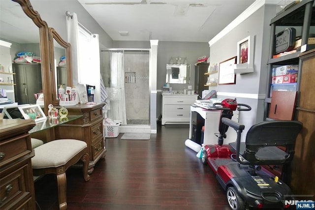 bathroom with hardwood / wood-style flooring and tiled shower