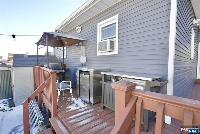 snow covered deck featuring cooling unit