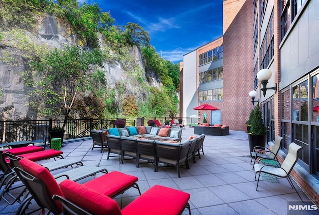 view of patio featuring an outdoor living space with a fire pit