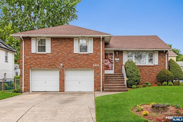 split level home with a garage and a front yard