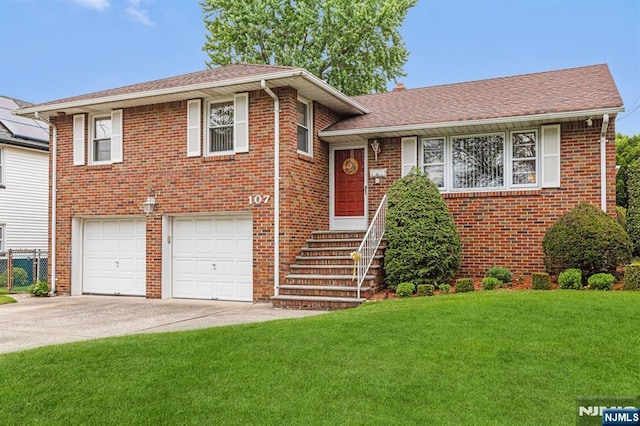 tri-level home with a garage and a front lawn