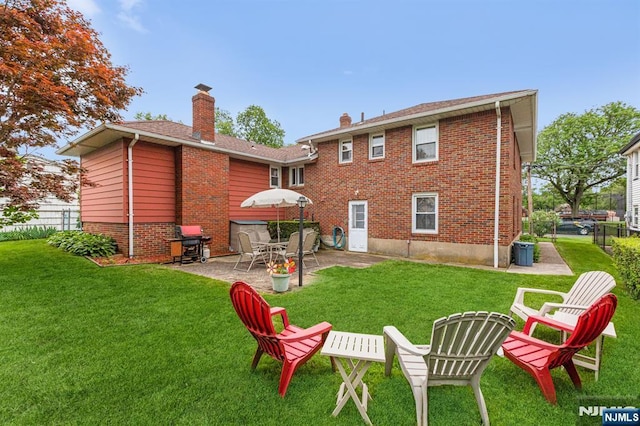 back of house with a lawn and a patio area