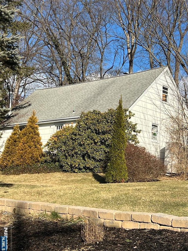 view of side of property with a lawn