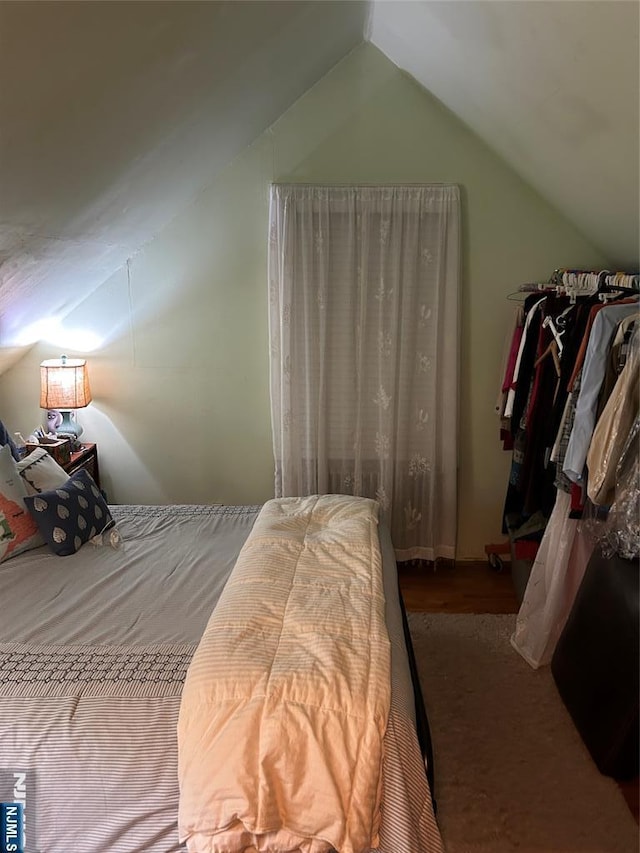 bedroom with lofted ceiling