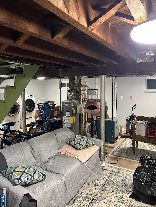 basement featuring washer and clothes dryer and water heater