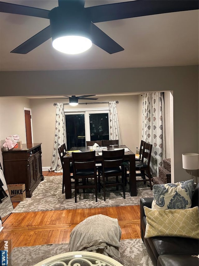 dining space featuring ceiling fan and wood-type flooring