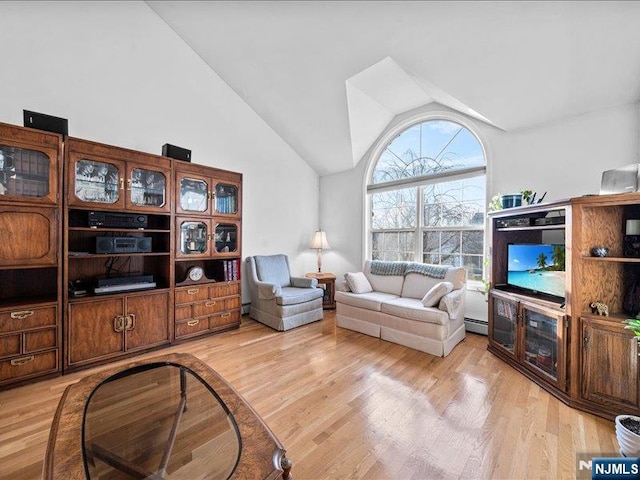 living room with baseboard heating, high vaulted ceiling, and light hardwood / wood-style floors