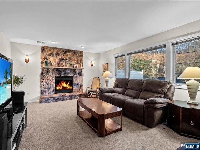 living room featuring carpet flooring and a fireplace