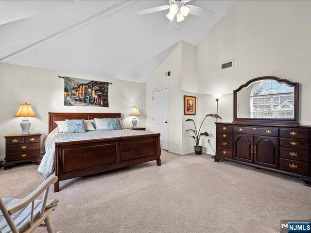 carpeted bedroom with high vaulted ceiling and ceiling fan