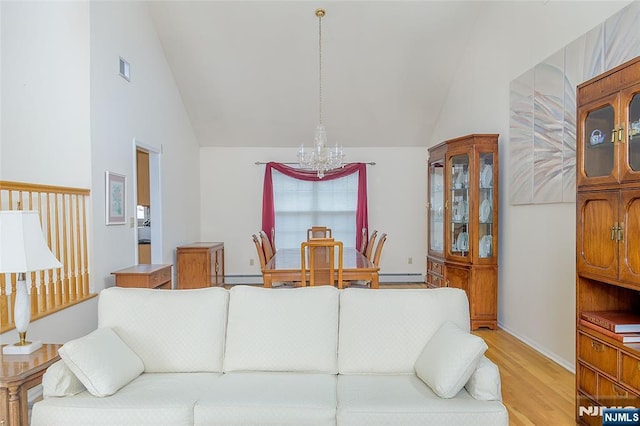 living room with baseboard heating, a chandelier, high vaulted ceiling, and light hardwood / wood-style flooring