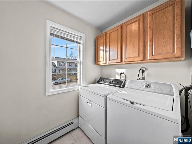 washroom with cabinets, a baseboard radiator, washer and dryer, and light tile patterned flooring