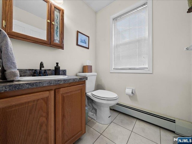 bathroom with baseboard heating, tile patterned floors, vanity, and toilet