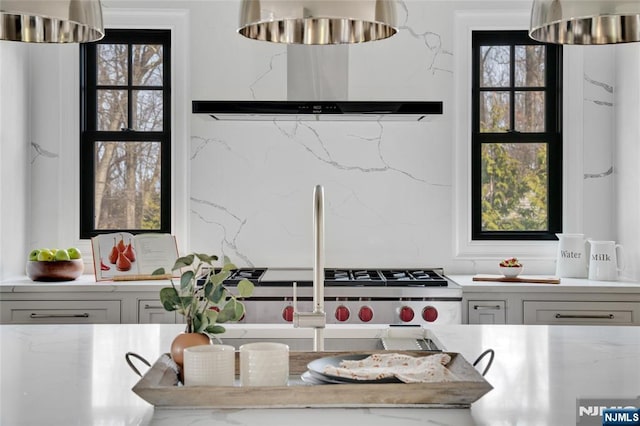 kitchen with white cabinetry, a healthy amount of sunlight, and wall chimney exhaust hood