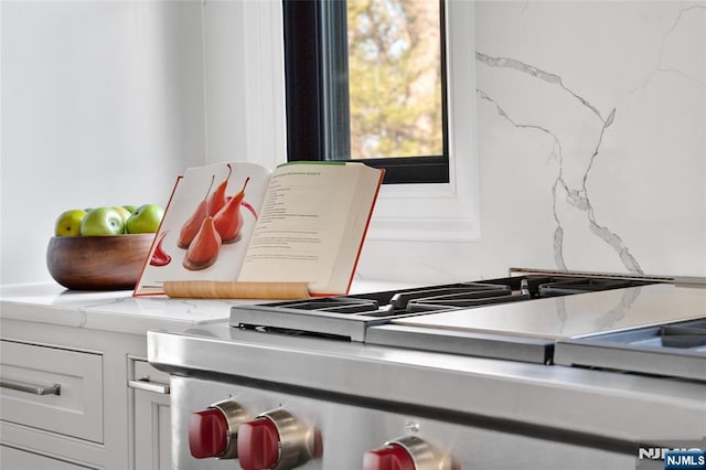 details with white cabinetry and stainless steel range