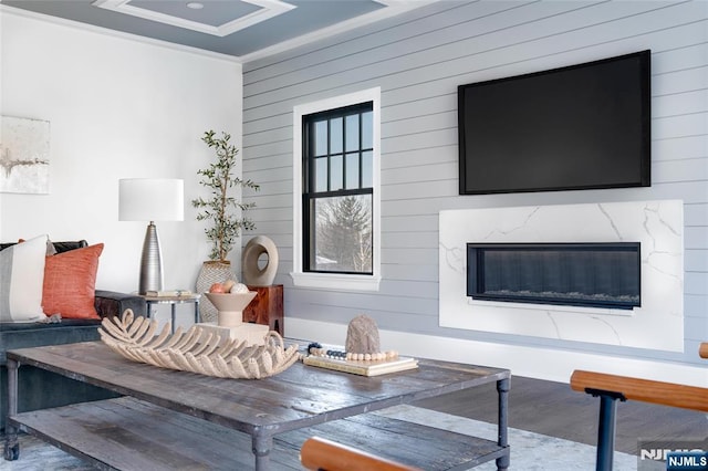 living room featuring crown molding and a high end fireplace