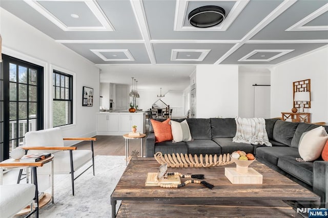 living room featuring coffered ceiling and hardwood / wood-style floors