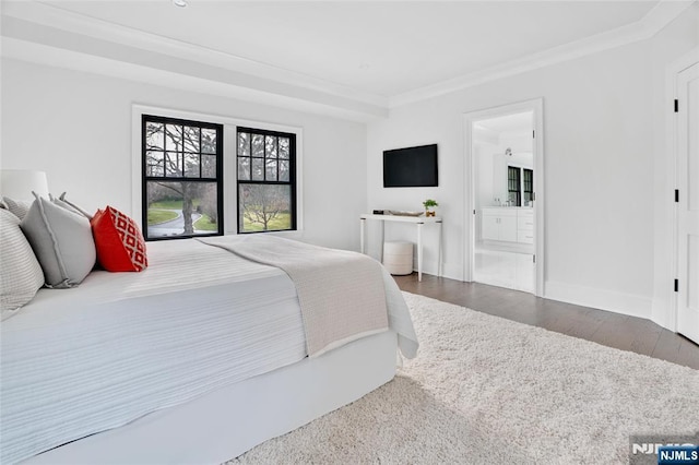 bedroom featuring hardwood / wood-style floors, crown molding, and ensuite bathroom