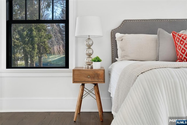 bedroom with dark wood-type flooring