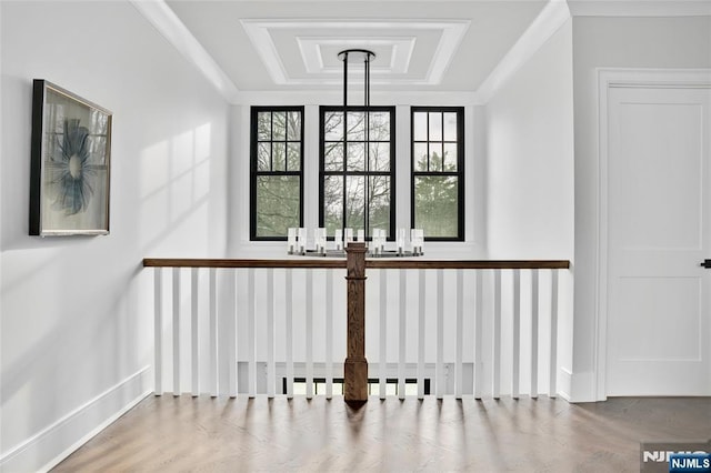 stairway with hardwood / wood-style floors, plenty of natural light, and a raised ceiling